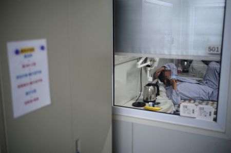 (miniature) Un patient du COVID-19 passe un appel téléphonique dans une salle d'isolement de l'hôpital Ditan