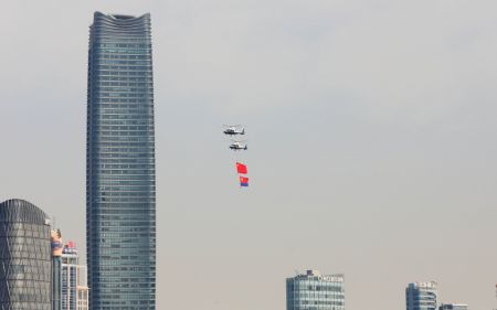 (miniature) Des hélicoptères tractant le drapeau national et le drapeau de la police volent au-dessus de Shanghai