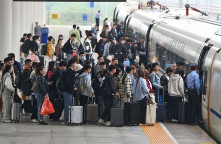 (miniature) Des passagers font la queue pour monter à bord d'un train dans la gare de l'Ouest de Fuyang