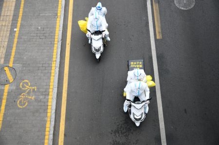 (miniature) Des livreurs emmènent des agents médicaux en moto vers un site de test d'acide nucléique à Xi'an