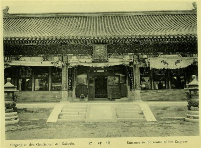 Photographie ancienne en noir et blanc de la façade du palais de l’Honneur terrestre : cinq travées, portes centrales ouvertes, stores de bambou relevés, deux brûle-parfums de bronze devant l’escalier.
