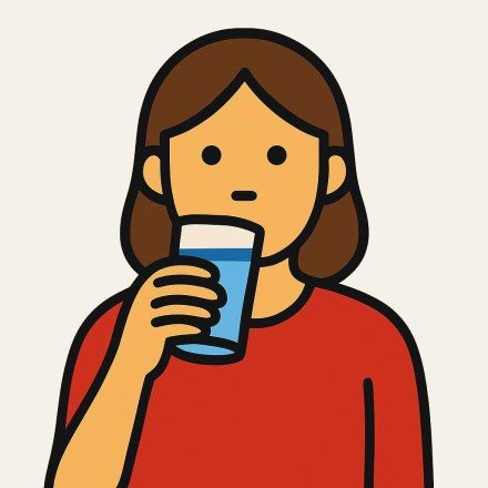 A woman drinking a glass of water.
