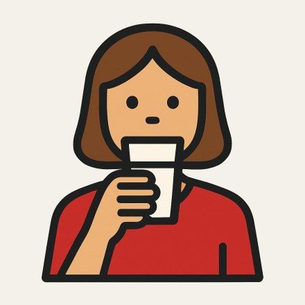 A woman drinking a glass of milk.