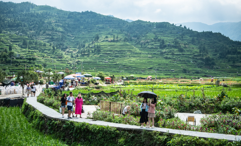 Des touristes visitent le village Miao de Xijiang Qianhu