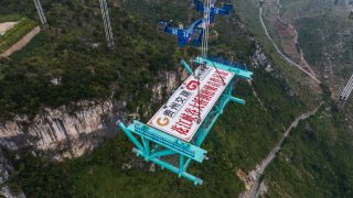 Photo aérienne du premier élément en acier du pont du grand canyon de Huajiang