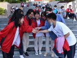 Des candidats s'encouragent mutuellement à l'extérieur d'un site d'examen dans un lycée du district autonome Miao de Songtao