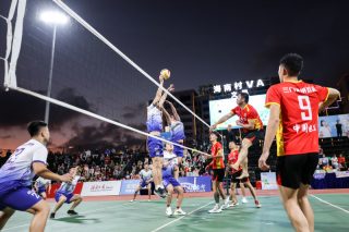 Des joueurs participent à un match de volley-ball au niveau de village à Wenchang