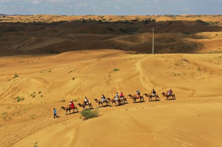 (miniature) Photo prise par un drone aérien montrant des touristes à dos de chameau dans le site touristique du désert de Yinkentala