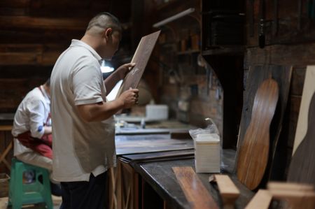 (miniature) Des travailleurs fabriquent des guitares dans le Parc industriel de guitares de Zheng'an