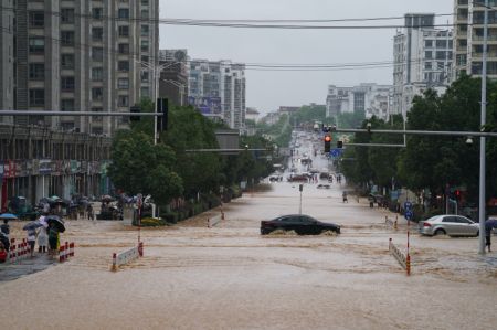 (miniature) Des véhicules circulent sur une route inondée du district de Shexian