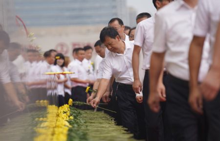 (miniature) Des gens pr&eacute;sentent des fleurs lors d'un &eacute;v&eacute;nement comm&eacute;moratif organis&eacute; &agrave; l'occasion de la Journ&eacute;e des martyrs de Chine