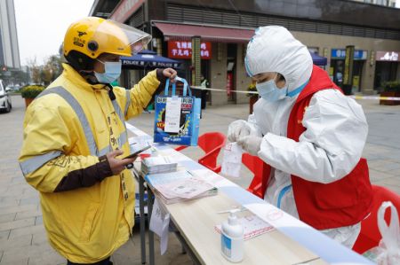 (miniature) Un employé fait la liste des produits de première nécessité commandés par les habitants d'un quartier résidentiel placé en quarantaine dans l'arrondissement de Chenghua à Chengdu