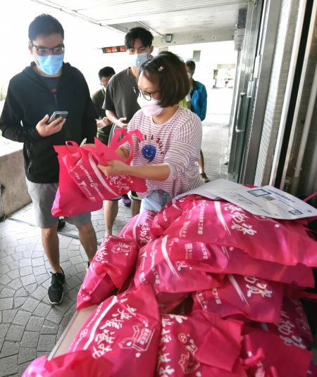 (miniature) Des membres de personnel distribuent des fournitures de contrôle de l'épidémie à Hong Kong