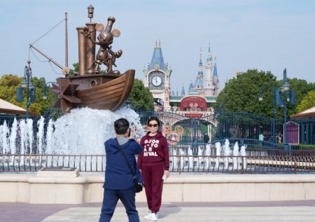 (miniature) Une touriste pose devant l'entrée du parc Shanghai Disneyland à Shanghai