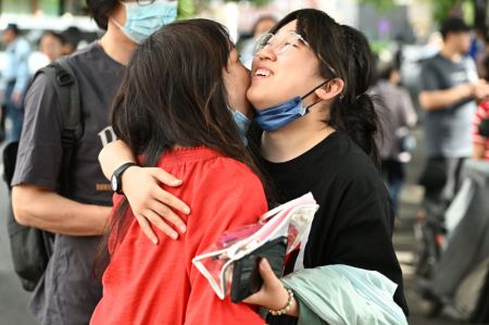(miniature) Une candidate embrasse sa mère avant de pénétrer dans le site d'examen du lycée expérimental rattaché à l'Université normale de Beijing