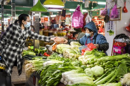 (miniature) Une habitante achète des légumes sur un marché à Dongxing