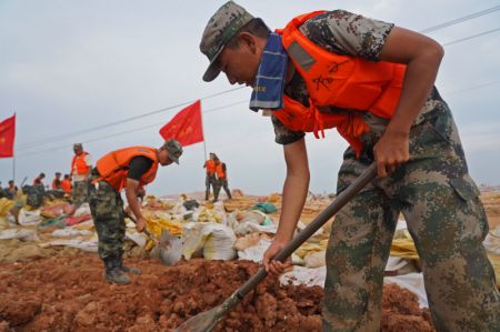 (miniature) Des vétérans bénévoles aident à consolider un remblai contre les inondations sur la rivière Changjiang