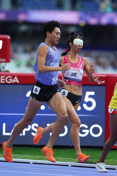 (miniature) He Shanshan (à droite) de la Chine et son guide You Junjie concourent lors de la finale du 1500m femmes T11 des Jeux paralympiques de Paris 2024 à Paris