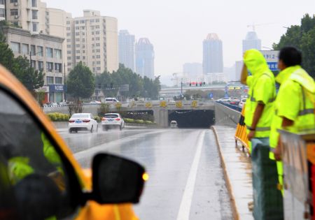 (miniature) Des membres du personnel travaillent à l'entrée d'un tunnel à Zhengzhou