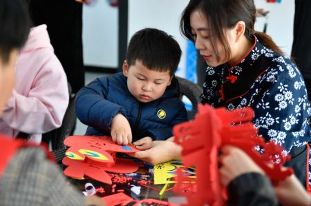 (miniature) Une habitante aide un gar&ccedil;on &agrave; fabriquer une lanterne dans le bourg de Miaoxi de la ville de Huzhou de la province chinoise du Zhejiang (est)