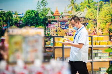 (miniature) Un visiteur achète des produits dans le pavillon de l'ASEAN lors de la Conférence mondiale sur le commerce numérique mondial de 2021 et de la Foire des marchandises de Wuhan (Hankoubei) à Wuhan
