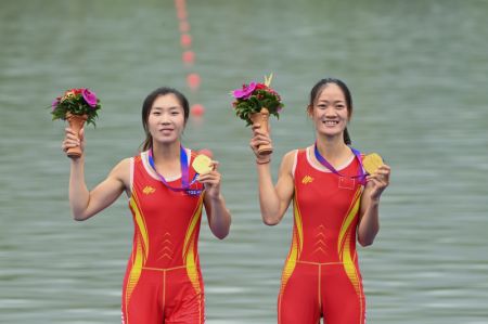 (miniature) Les Chinoises Zou Jiaqi (à gauche) et Qiu Xiuping lors de la cérémonie de remise des médailles pour l'épreuve d'aviron du deux de couple poids léger femme aux 19es Jeux asiatiques à Hangzhou